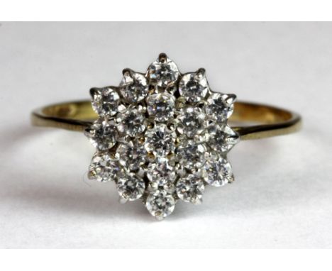 A 9ct gold cubic zirconia cluster ring (R).