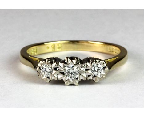 An 18ct yellow and white gold three diamond set ring (J.5).