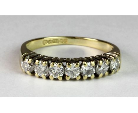 An 18ct gold diamond set half eternity ring (approx. 0.60ct, Est. Colour G/F, clarity VS) (I.5).