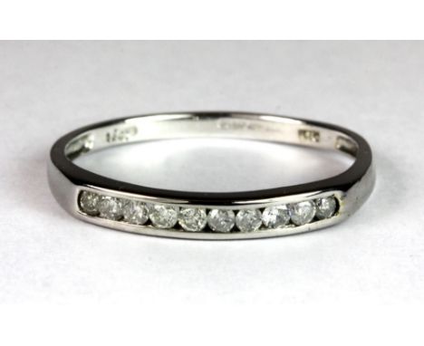 A 9ct white gold diamond set half eternity ring, (approx. 0.25ct diamonds) (S.5).