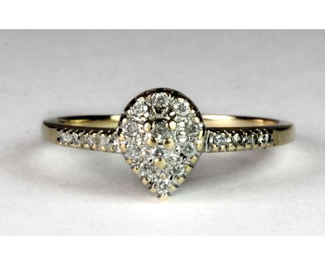 A 9ct gold pear shaped diamond cluster ring with diamond set shoulders (S).