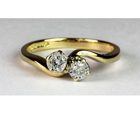 An 18ct gold two diamond crossover ring (K.5).
