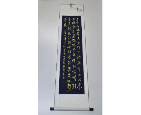A silk mounted Chinese scroll of gilt caligraphy, W. 43cm.