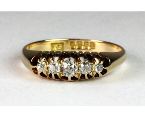 An 18ct gold ring set with five old cut diamonds (P).
