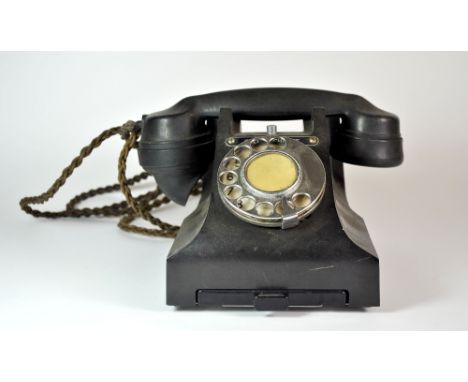 A vintage black Bakelite telephone.