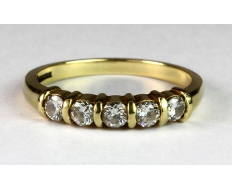 A yellow metal (tested 18ct gold) ring set with five diamonds (O.5).