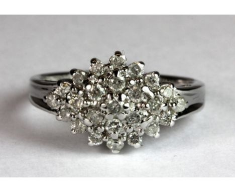 A 9ct white gold cluster ring set with approx. 0.5ct of diamonds (M).