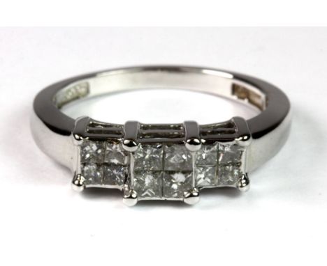 An 18ct white gold contemporary ring set with 12 princess cut diamonds (M).