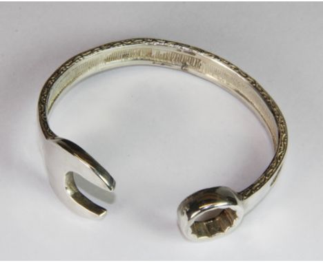 A heavy silver "spanner" bangle (approx 50g).
