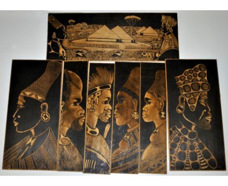 A large vintage leather case containing African poker work wooden panels, largest 76 x 29cm.