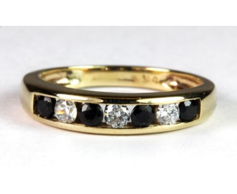 A 9ct gold diamond and sapphires half eternity ring, (M).