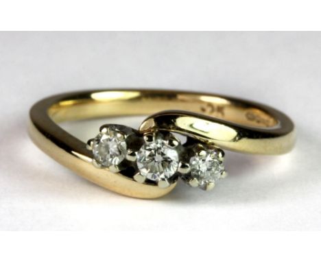 A 9ct gold three diamond crossover ring, (approx. 0.50ct diamonds) (N.5).