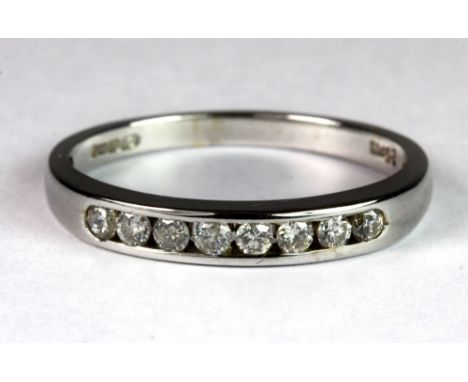 A 9ct white gold diamond set half eternity ring, (approx. 0.25ct diamonds) (P).