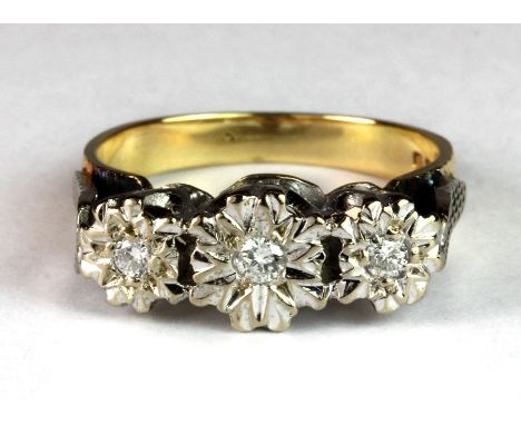 An 18ct yellow and white gold three diamond set ring (M.5).