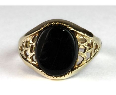 A 9ct gold onyx set signet ring (P.5).