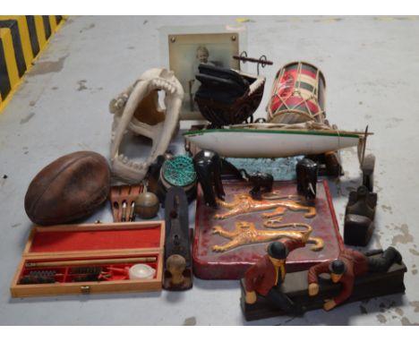 A collectors' lot comprising ornamental skull, gas mask, a drum, a small boat, a ceramic plaque decorated with two lions, woo