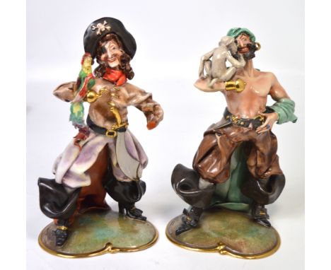 A pair of 20th century ceramic figurines of pirates, one holding a monkey, the other a parrot, height of both 28cm (2).