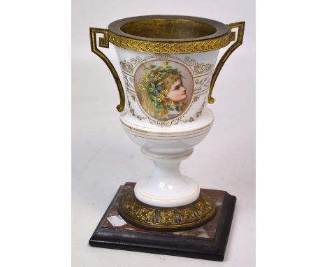 A Continental porcelain twin handle urn shaped vase with an hand painted portrait of a young woman on a marble base, height 2