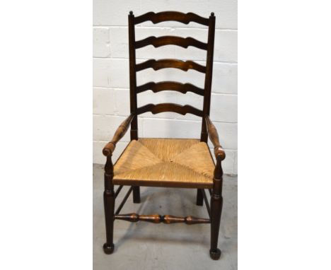 A country style oak ladder back armchair.