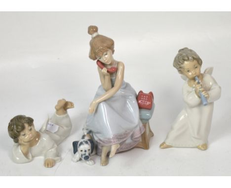 Three Lladró figurines to include two angels, one reclining and one playing a trumpet and a seated figure of a young girl spe