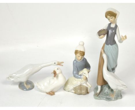 Three Lladró figures, a goose girl feeding a goose, a girl holding a lamb, a goose and a Nao figure of a duck (af) (4).