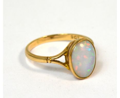 A 9ct gold dress ring set with an oval opal, size O, approx 2.3g.