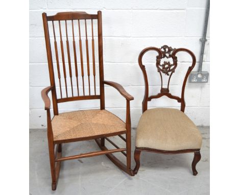 A rush seated stick back rocking chair and a walnut upholstered low chair with ornately carved splat (2).