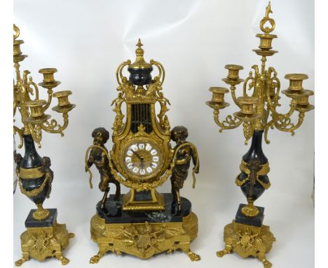 A large reproduction heavy brass mantel clock, the dial set with Roman numerals, height 60cm, and a pair of six branch urn sh