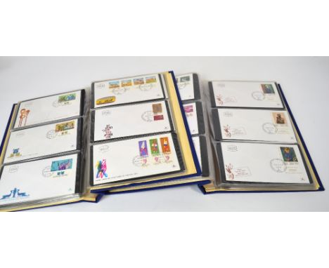 Two blue albums of first day covers.