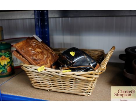 A wicker basket containing a camera; magnifying glass; Religious plaques etc