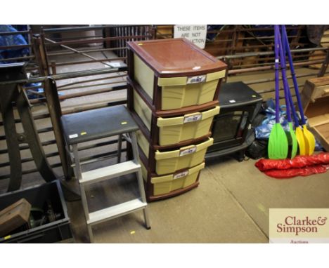 A step stool; and a bank of plastic drawers 
