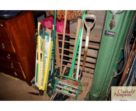 A lawn aerator; garden edges; various garden tools and a landing net
