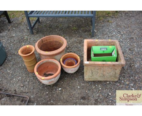 A square garden planter and a collection of circular planters 