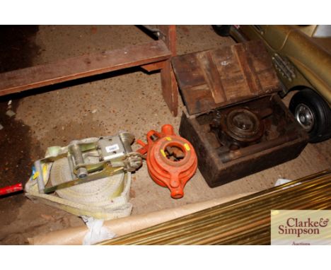 A heavy duty ratchet strap and two pipe cutters 