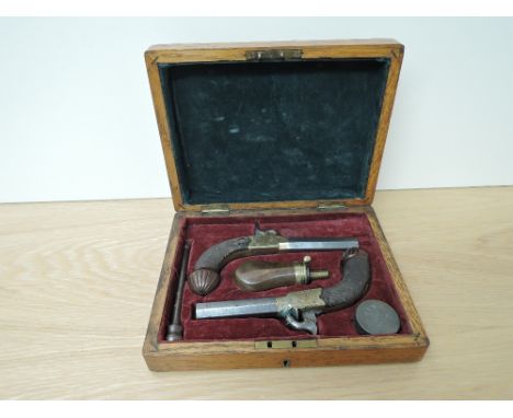 A cased pair of Bentley Liverpool Turn Barrel Percussion Revolvers, drop down triggers, chequered grips, carved wooden pommel