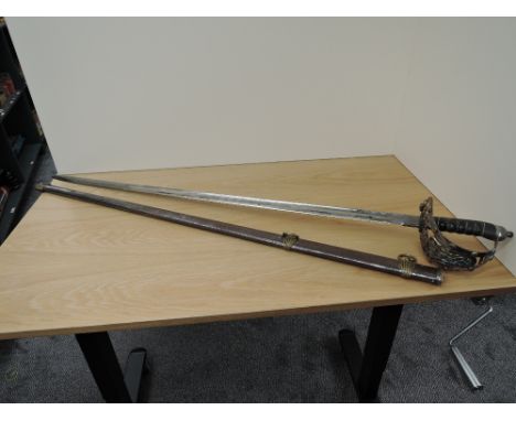 A Victorian Household Cavalry Officers Sword, Cipher on guard, decorated blade with Royal Cipher, metal scabbard with two rin
