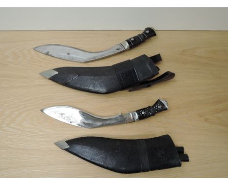 Two Kukri Knifes, one inscribed on blade India, black decorated handle with scabbard with two small knives, blade length 22cm