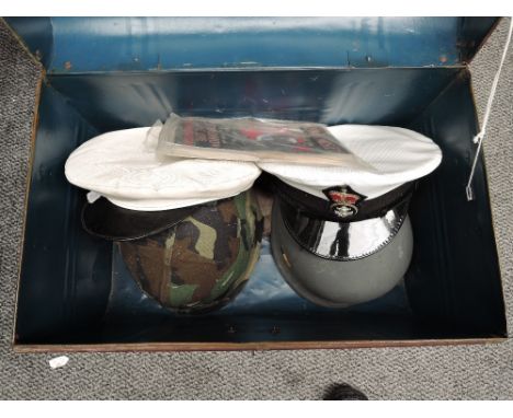 A Tin Trunk containing a Canvas Pistol Holster, Leather Pistol Holster, American Camouflage Steel Helmet, Modern Steel Helmet