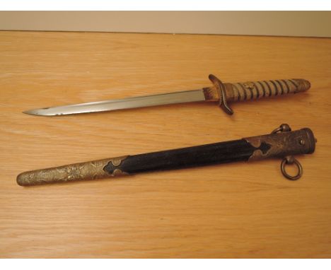 A World War II Japanese Naval Officers Dagger having gilt wire wound handle with shagreen grip and leaf decorated pommel, gil