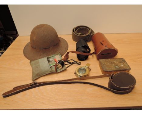 A collection of Military Items, WWII Steel Helmet, WWI Queen Mary Tin, House Wife Kit, Webbing Belt, Brass Military Compass 1