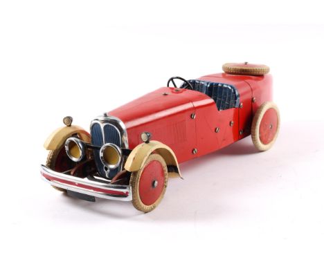 A rare 1930's No.2 Meccano Constructor Car. A boat tail example in red with cream front mudguards, blue seat, red wheels with