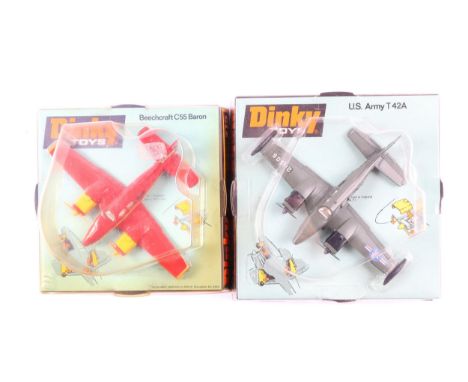 2 Dinky Toys light aircraft. US Army T 42A (712) in olive green. Plus a Beechcraft C55 Baron (715) in red with yellow engine 