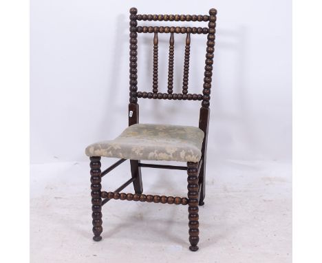 An Edwardian bobbin turned nursing chair, with upholstered seat 