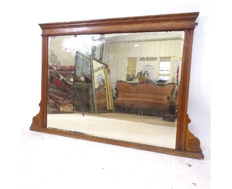 An early 20th century oak-framed bevel-edge over mantel mirror, W128cm, H84cm 