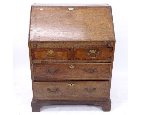 A George III crossbanded oak bureau, the fall-front revealing a 3-stepped pigeon hole and drawer interior, with 2 short and f