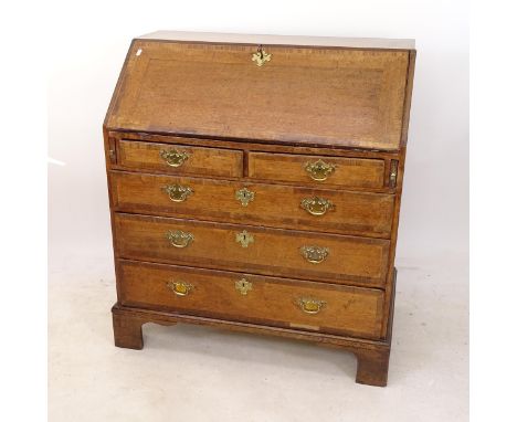 An 18th century crossbanded oak bureau, with a fitted interior, 2 short and 3 long drawers, on bracket feet, with key, W95cm,