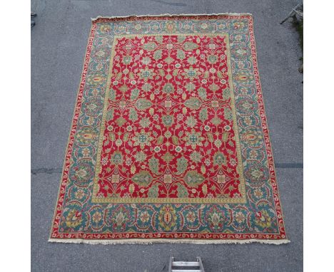 A red ground Persian design carpet, floral symmetrical decoration, 365cm x 276cm Carpet is in good overall condition, just so