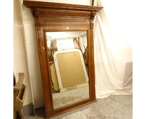A large over mantel mirror, with carved oak frame and lion decoration, W120cm, H168cm 