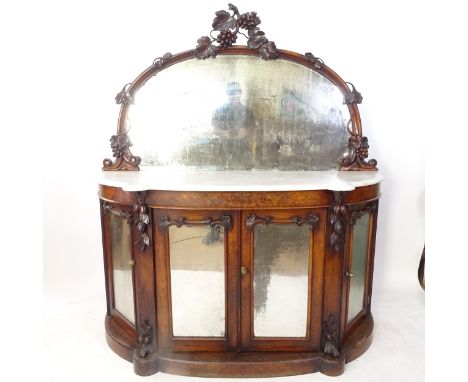 A Victorian walnut bow-front chiffonier, with raised mirror-back, shaped marble top, and mirrored glazed panelled cupboards u