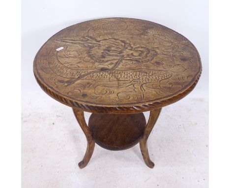 A carved beech circular 2-tier lamp table, W53cm, H70cmOne leg repaired, a lot of movement in the joints. Top is slightly bow